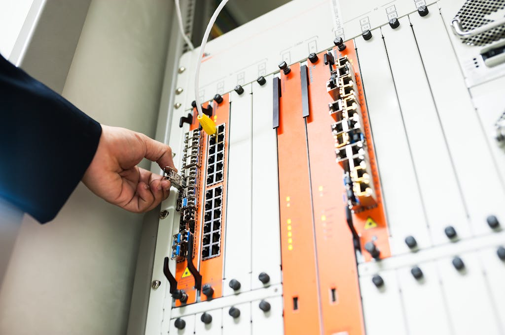 Home+ Close Up Of A Hand Adjusting Network Equipment In A Data Center. 19226352 1024x681